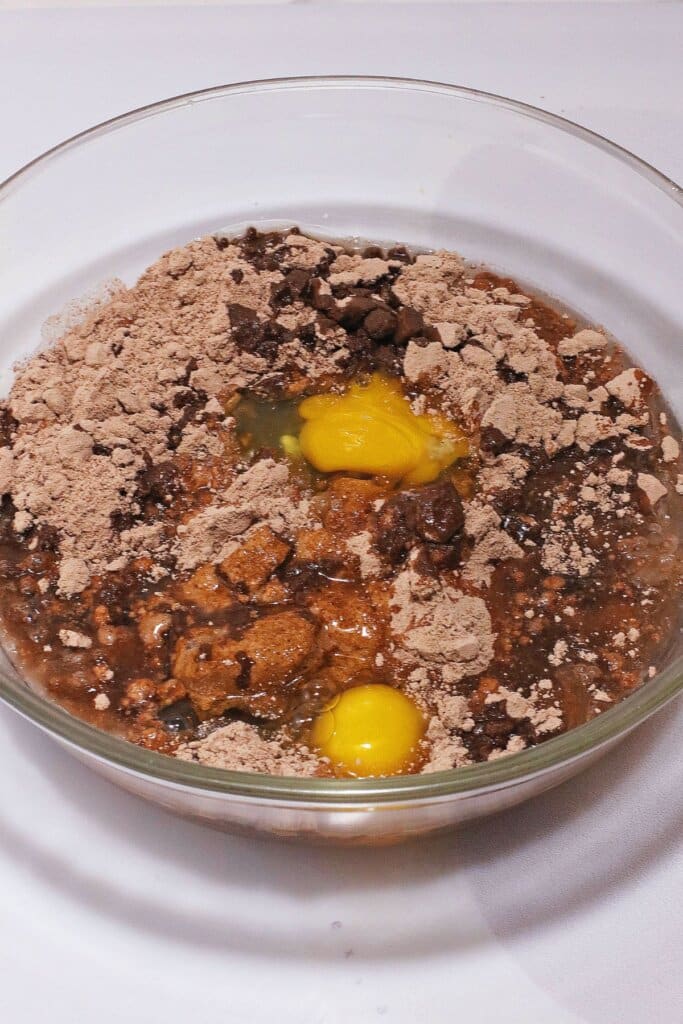 Batter being mixed in a glass mixing bowl.