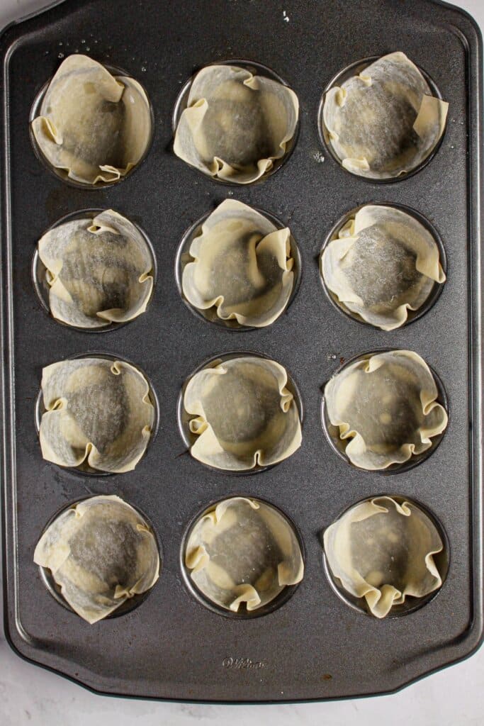 Wrappers placed in a muffin pan.