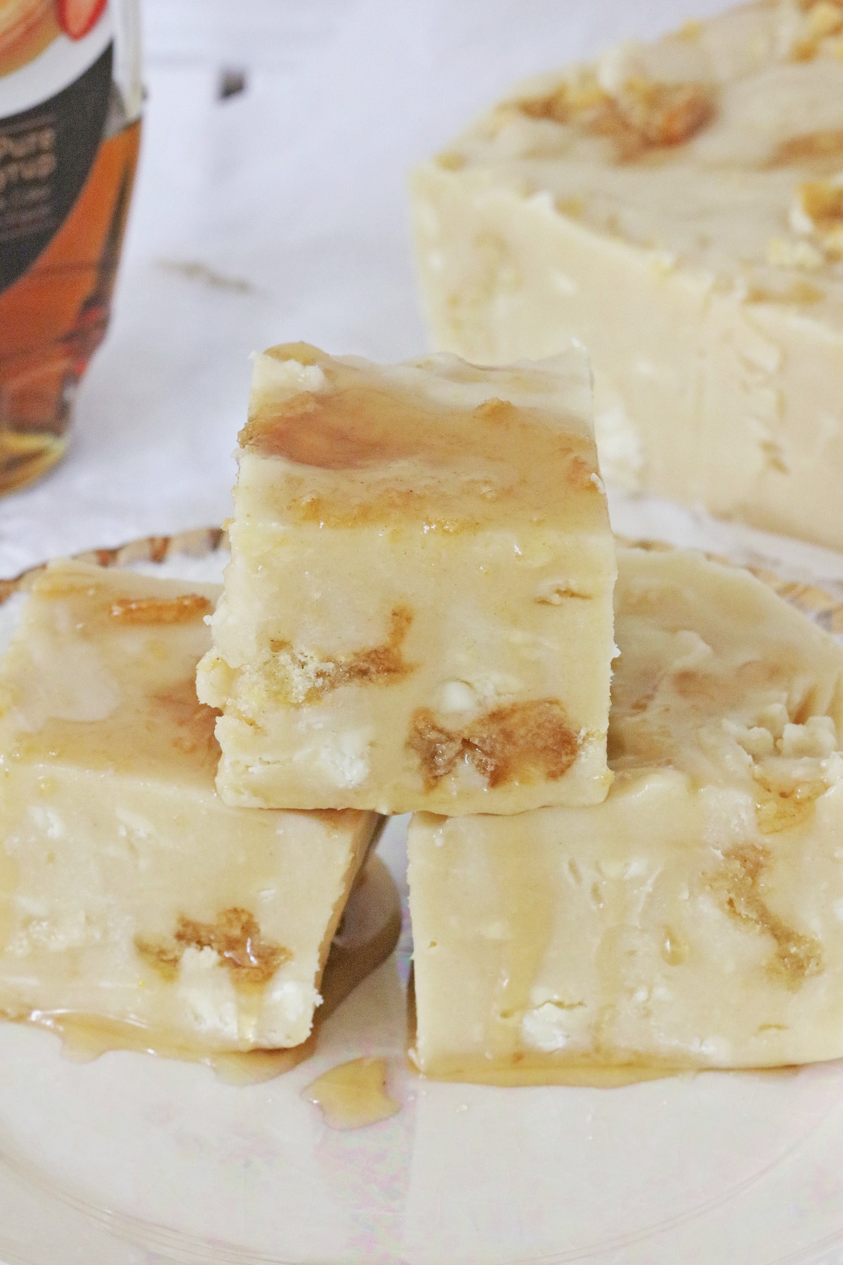 Three pieces of fudge on a white and gold plate.