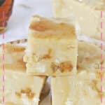 Three pieces of fudge on a white and gold plate.