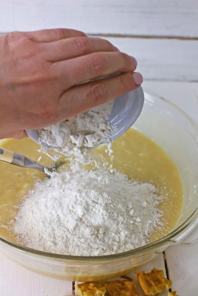 Flour being added to melted white chocolate.