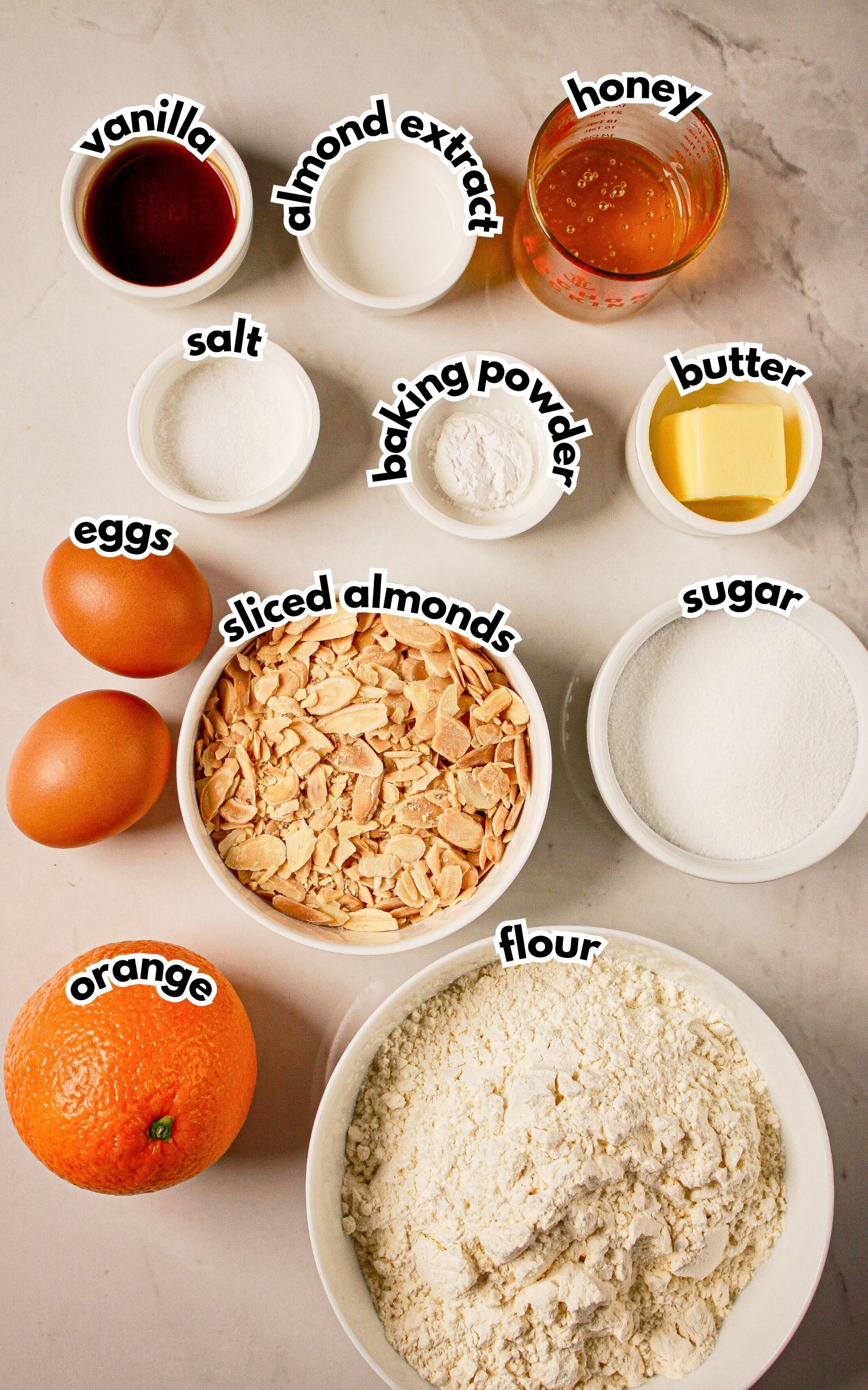 Bowls of ingredients labelled with text on a counter.