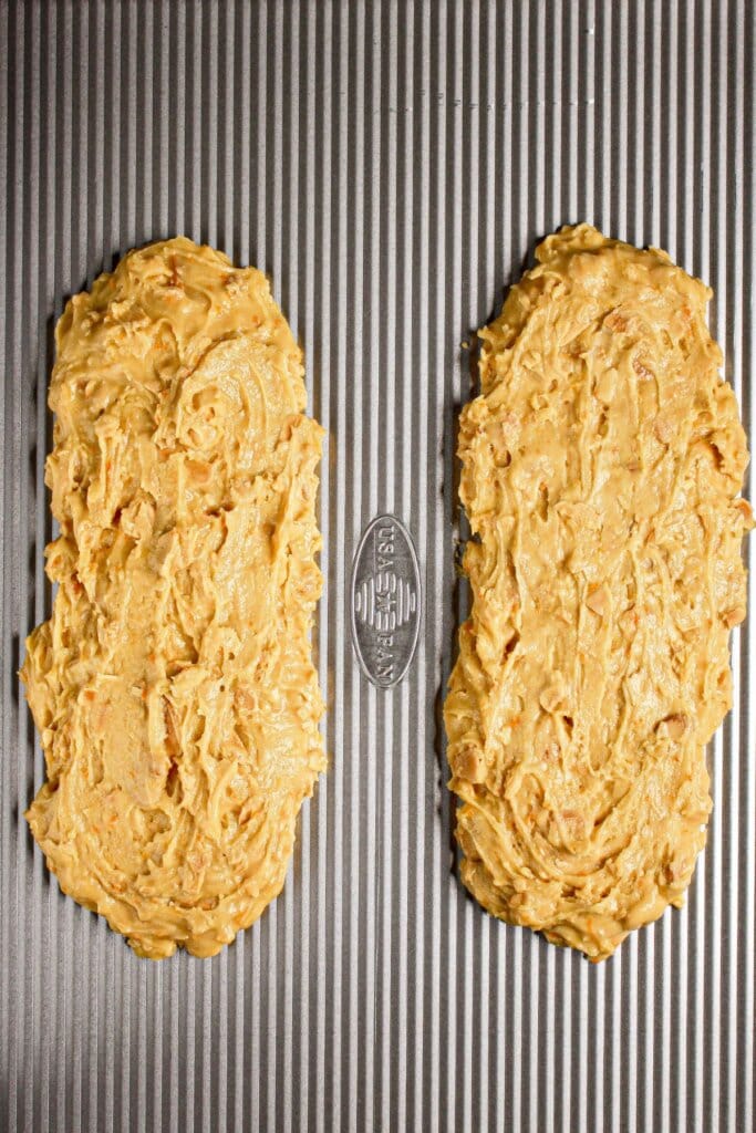 Dough shaped into two halves on a baking sheet.
