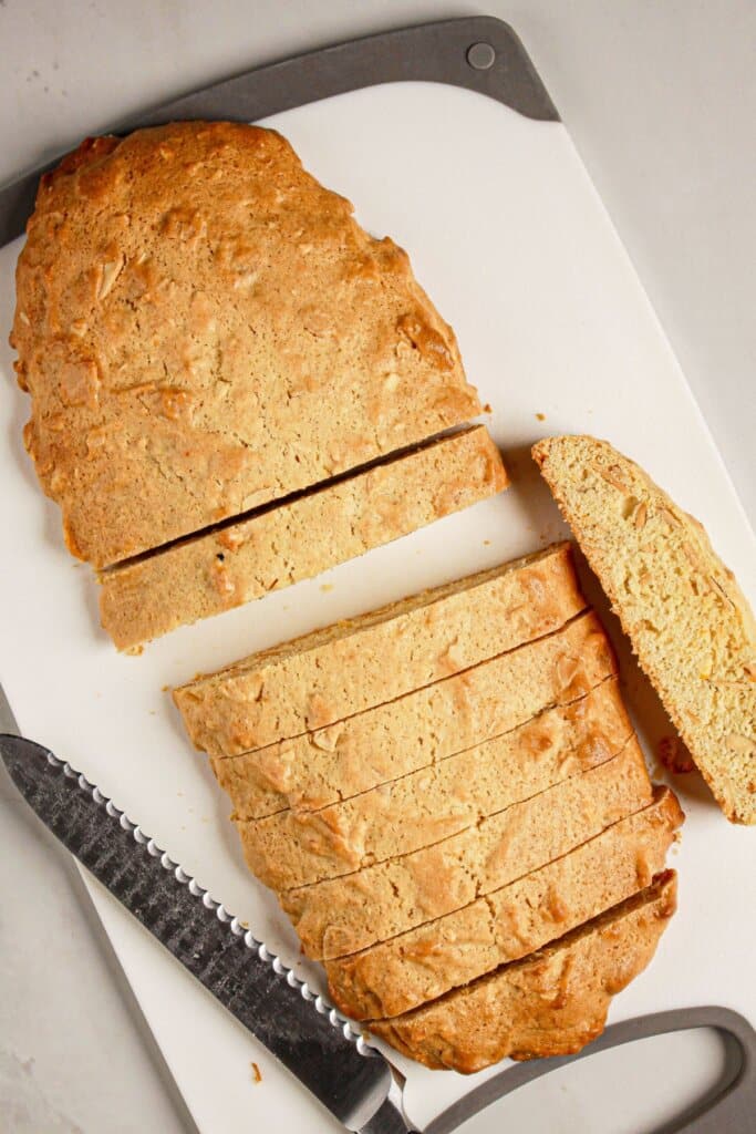 Cookies baking sliced on a cutting board.
