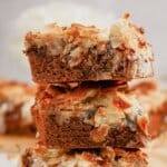 Almond joy magic cookie bars stacked on top of each other.