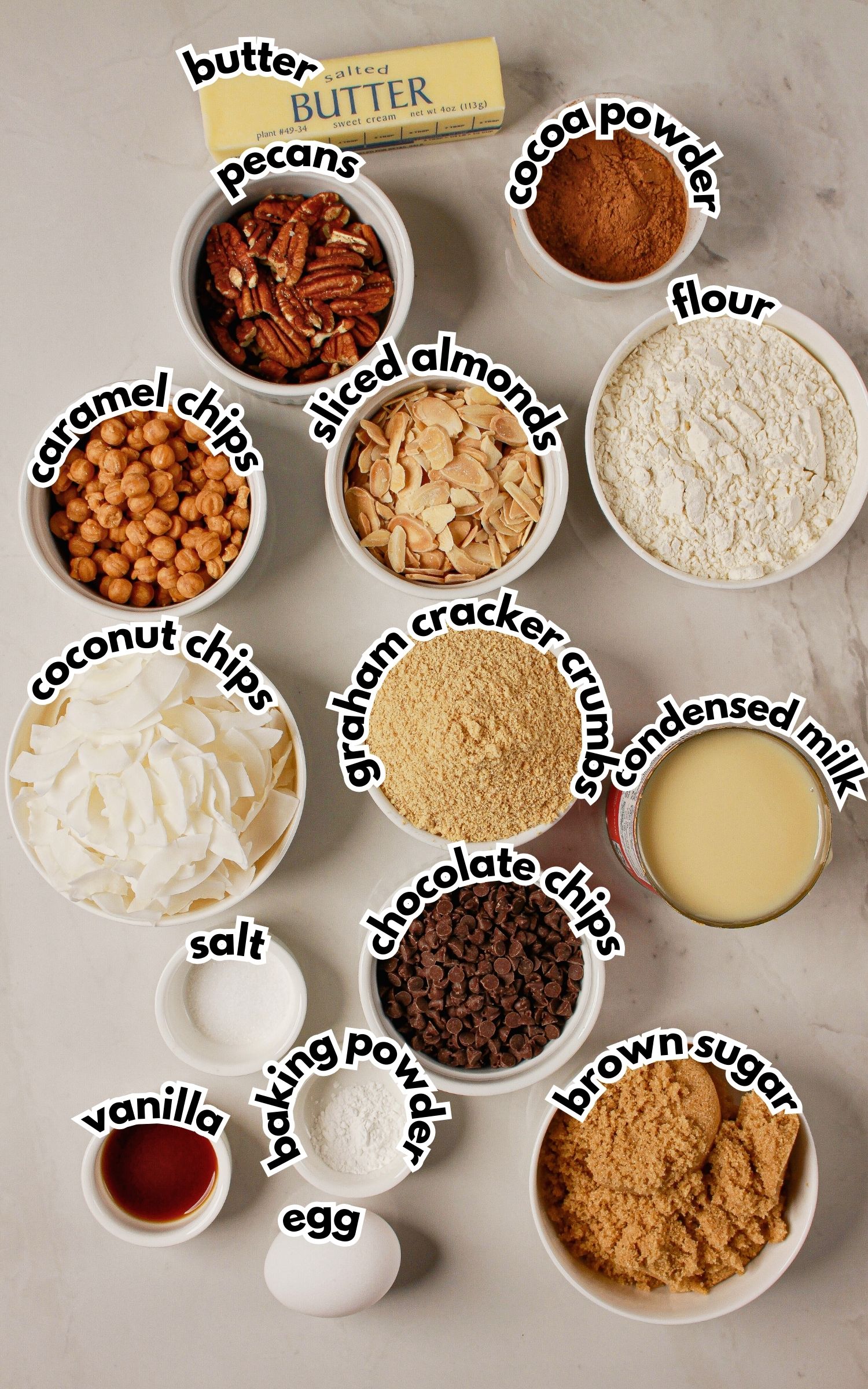Bowls of ingredients labelled with text on a counter.