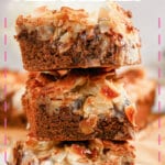 Almond joy magic cookie bars stacked on top of each other.