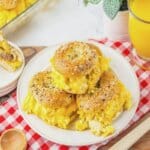 Three breakfast bagel sliders on a plate.