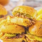 Slow Cooker Brisket Sliders Three brisket sliders stacked on each other.