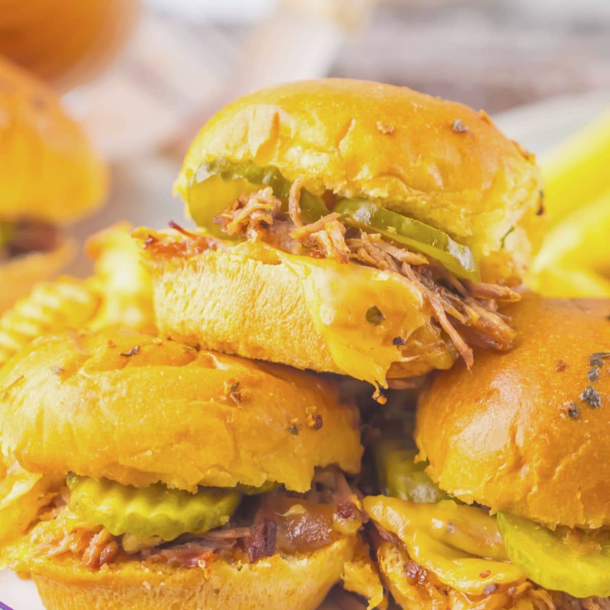 Three brisket sliders stacked on each other.