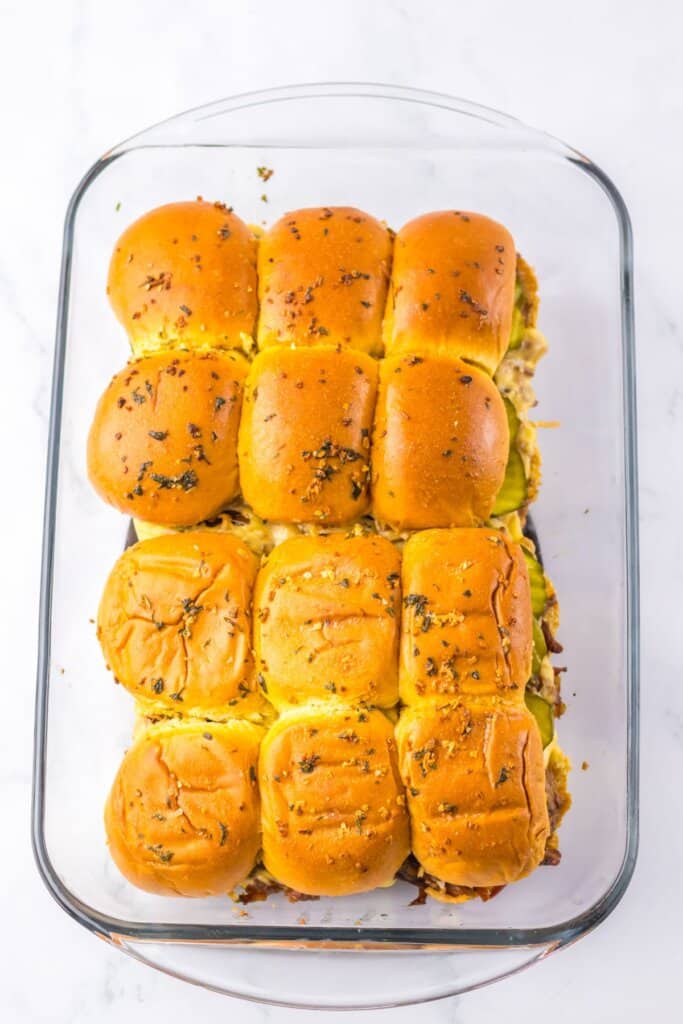 Sliders baked in a glass baking dish.