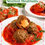 Cheese stuffed meatballs on a white plate.