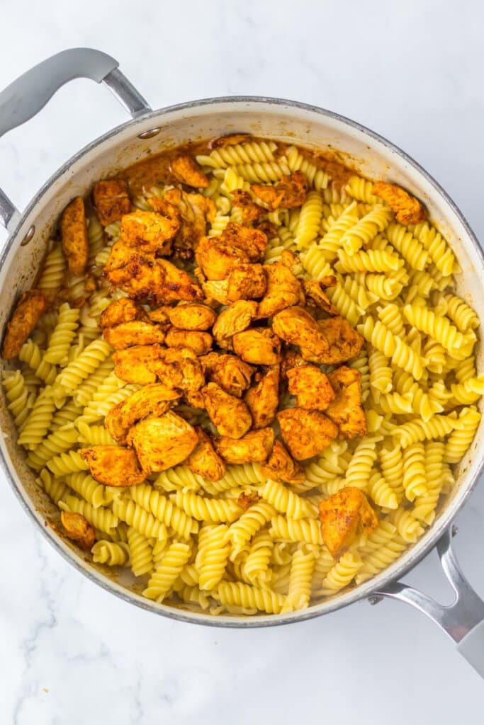Pasta and chicken in a skillet.