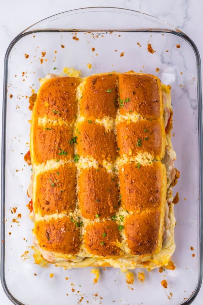 Rolls topped with butter and baked until golden brown in a baking dish.