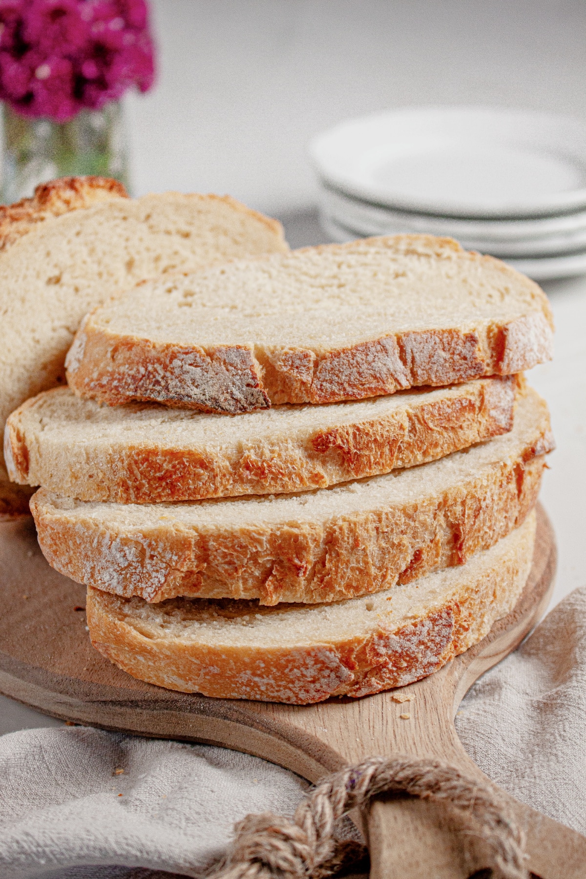 Slices of sourdough bread on a wooden cutting board.