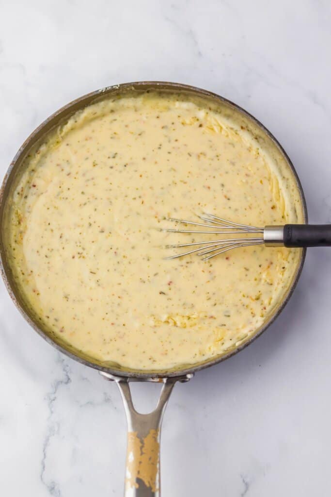 Sauce being mixed in a large skillet.