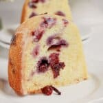 Slice of lemon blueberry bundt cake on a plate.