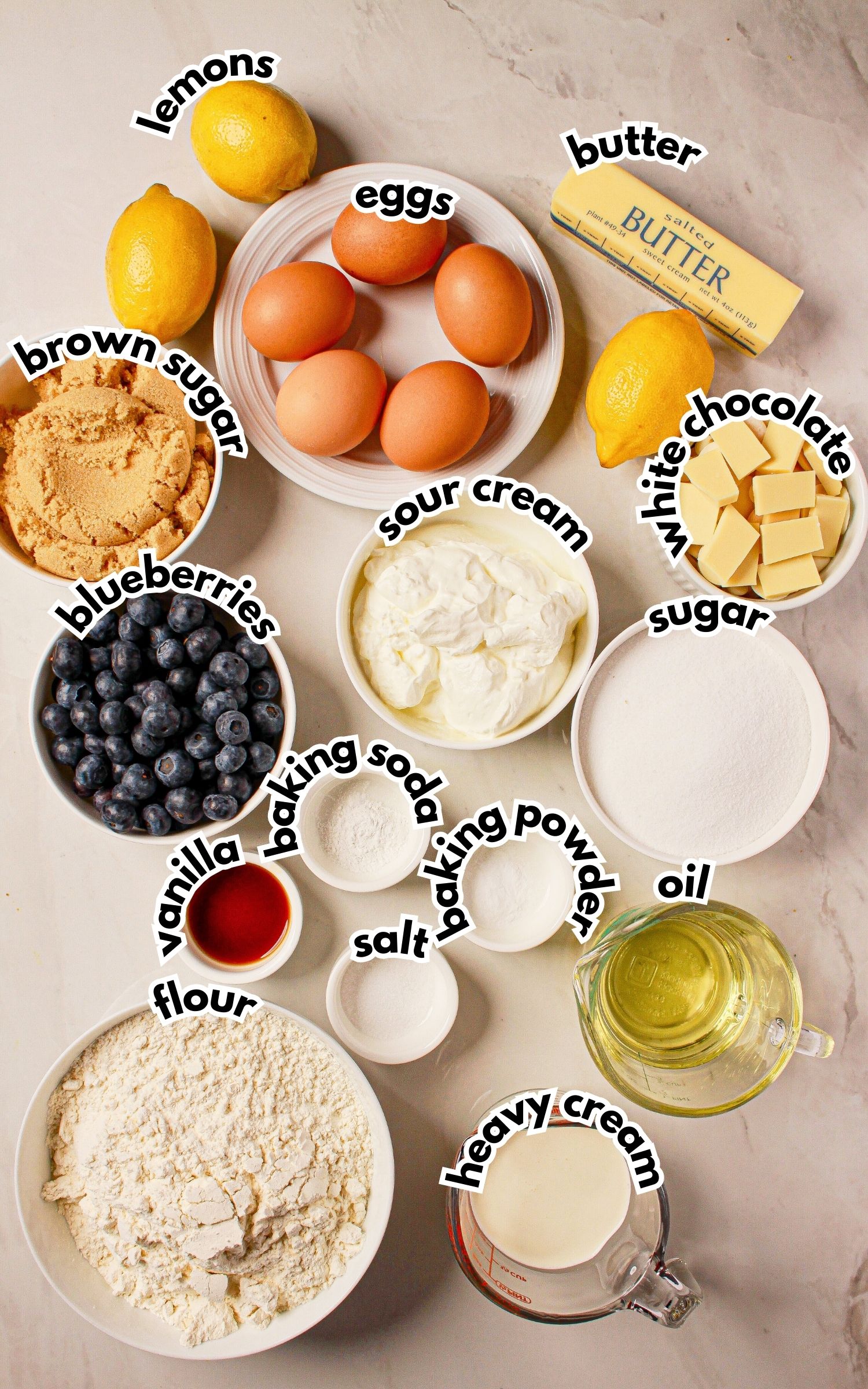 Bowls of ingredients labelled with text on a counter.