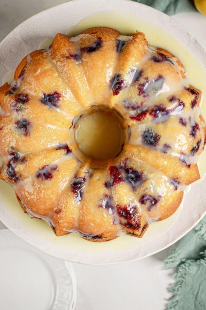 Whole lemon blueberry bundt cake on a serving platter.