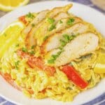 Lemon Chicken and Orzo Plate full of lemon chicken orzo on a table.