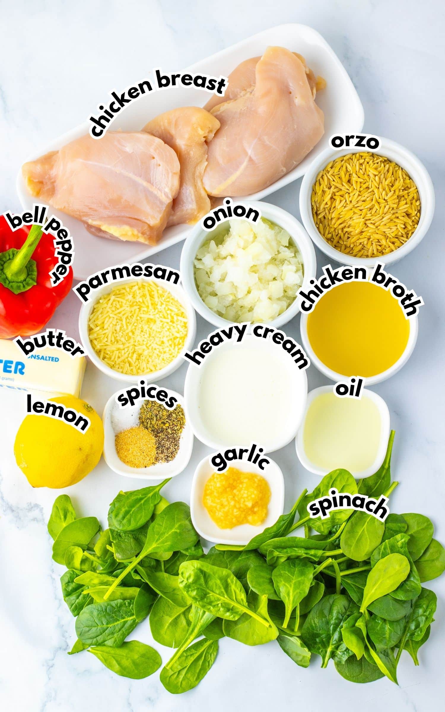 Bowls of ingredients labelled with text on a counter.
