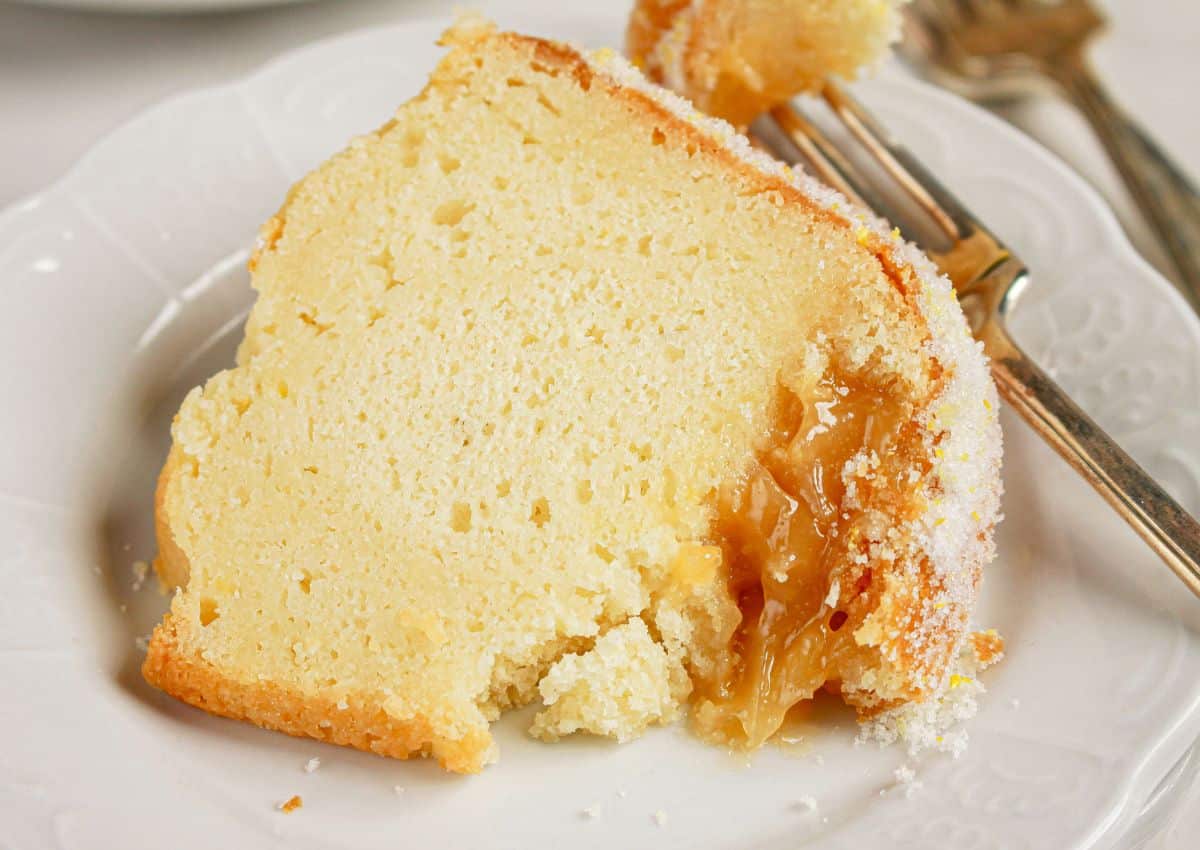 Slice of lemon curd bundt cake on a plate.