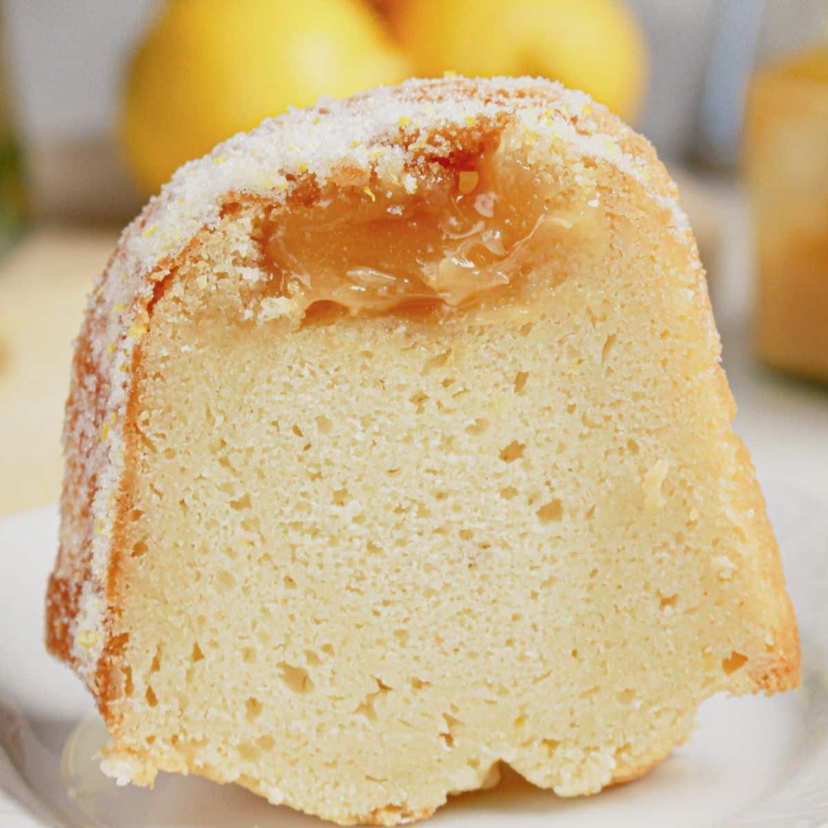 Slice of lemon curd bundt cake on a plate.