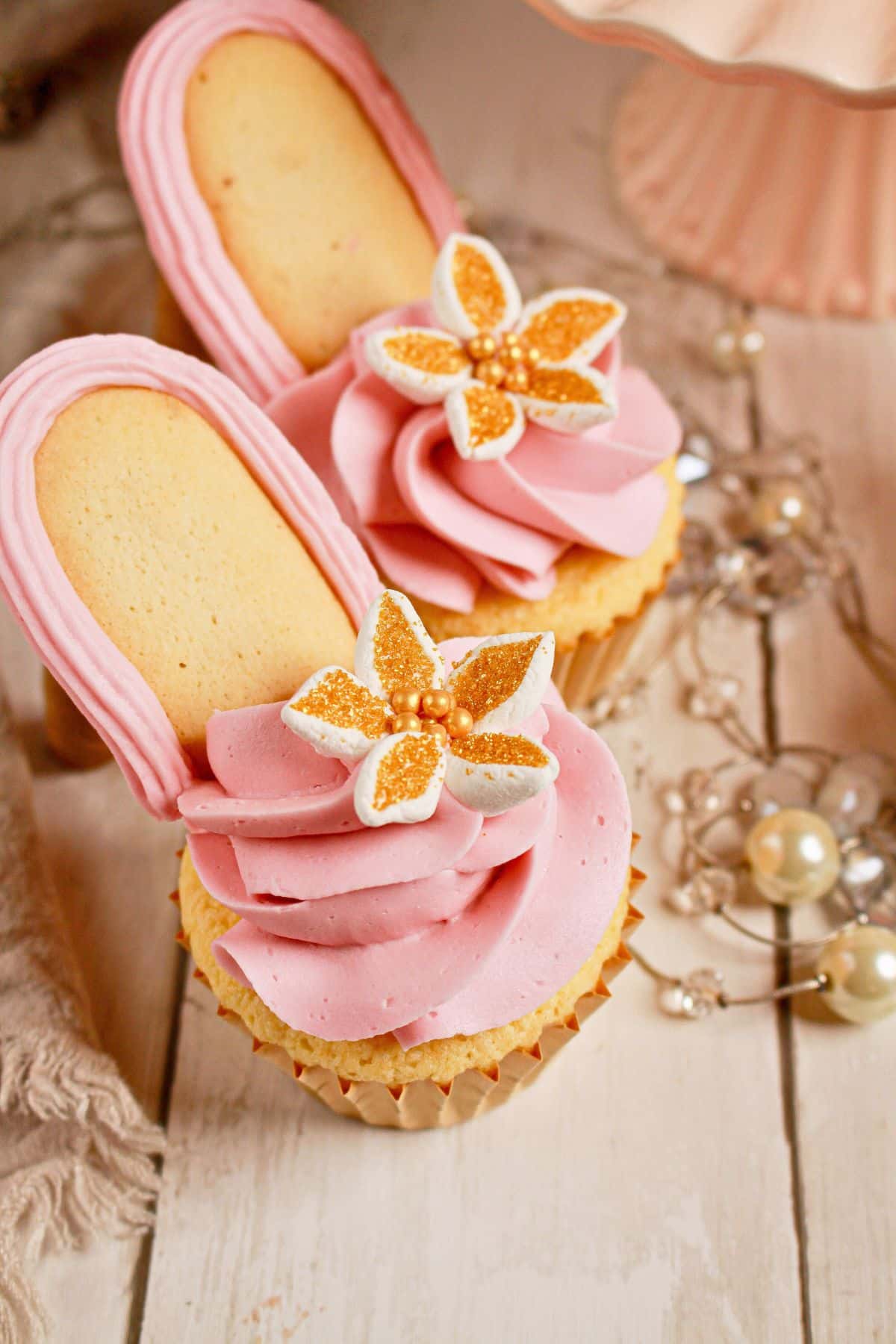 Two high heel cupcakes on a counter.