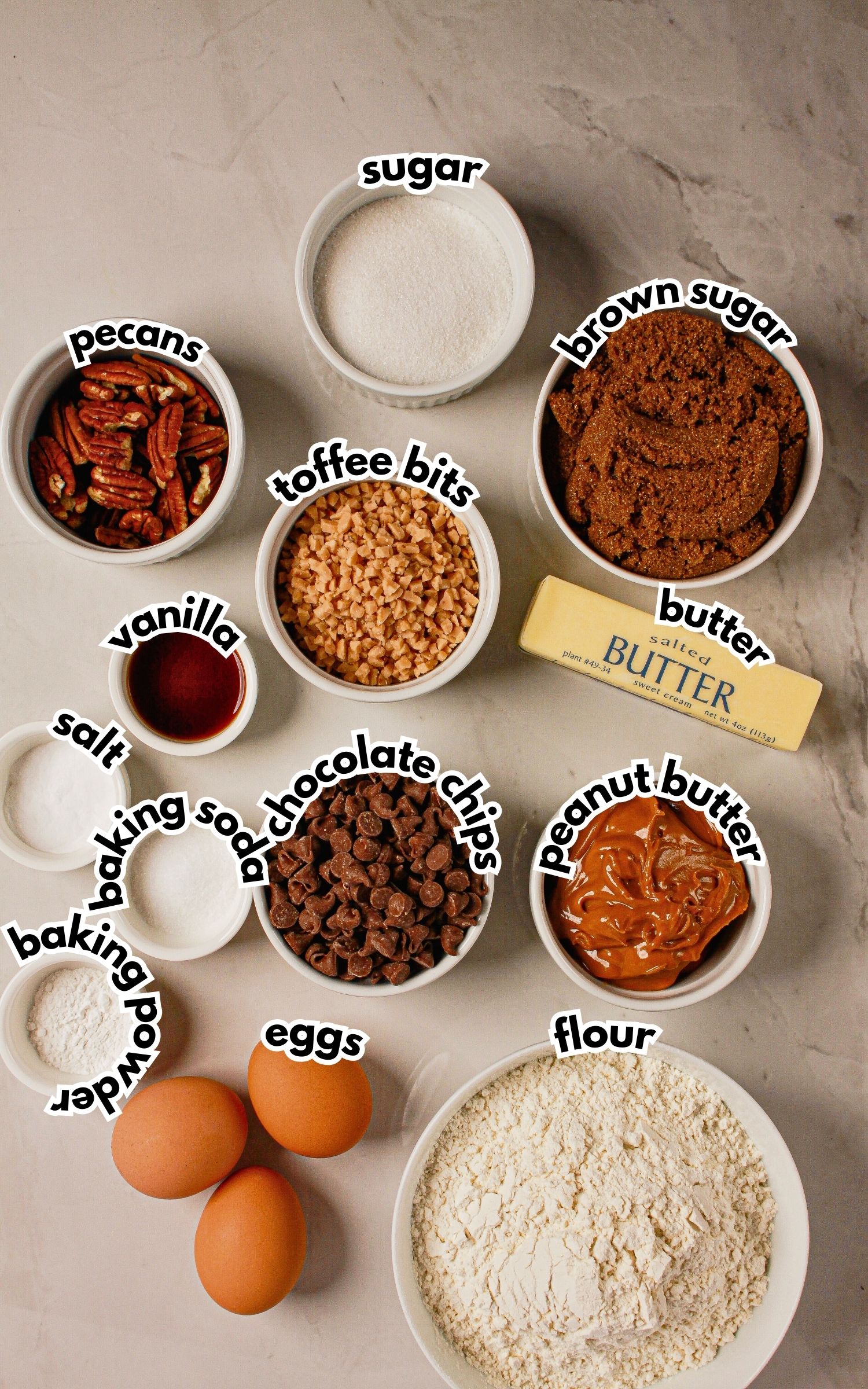 Bowls of ingredients labelled with text on a counter.