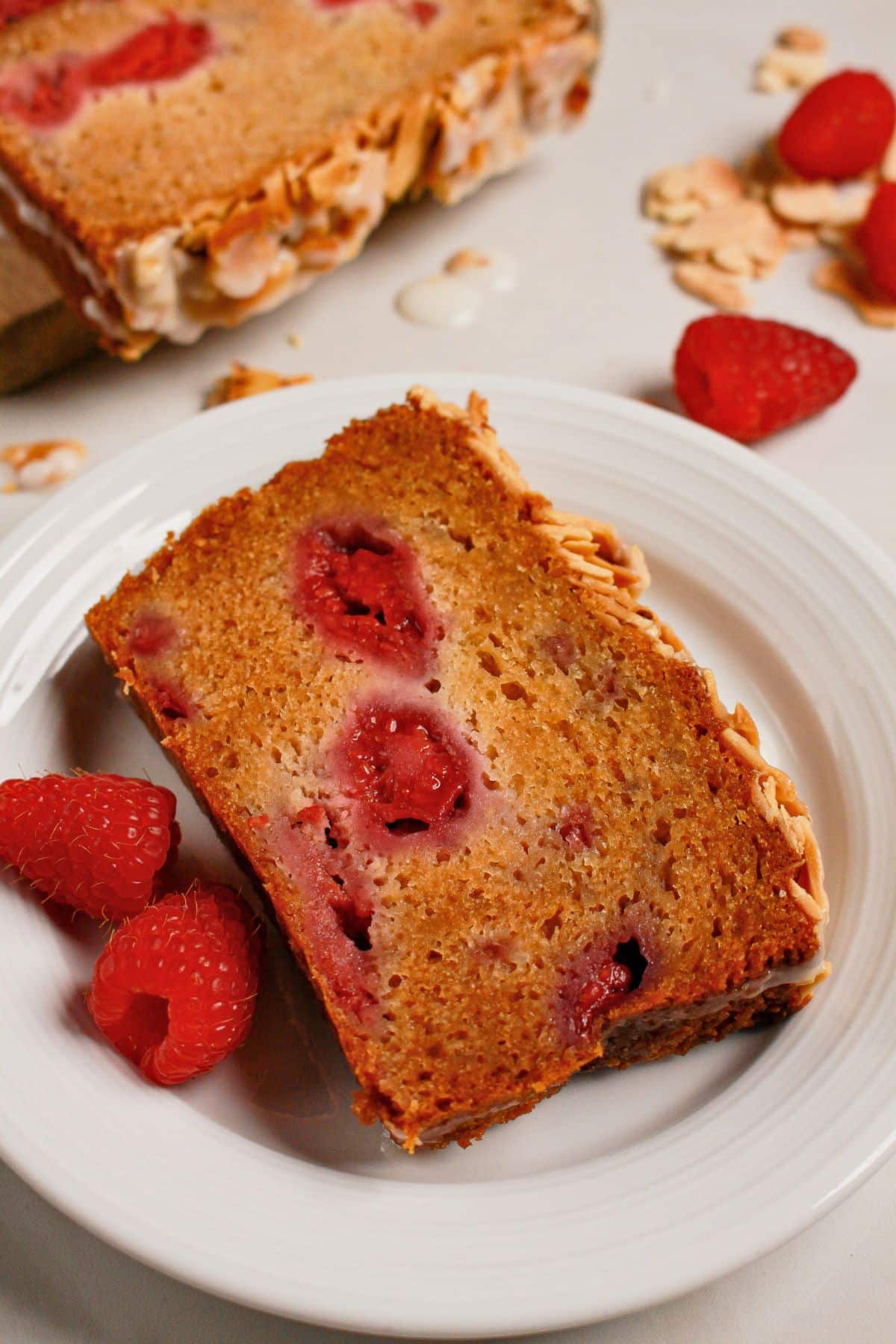 Slice of raspberry bread on a white plate.