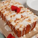 Whole loaf of raspberry lemon bread on a cutting board.