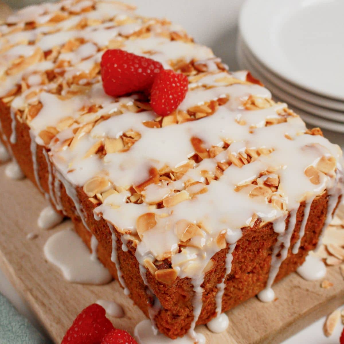 Whole loaf of raspberry lemon bread on a cutting board.