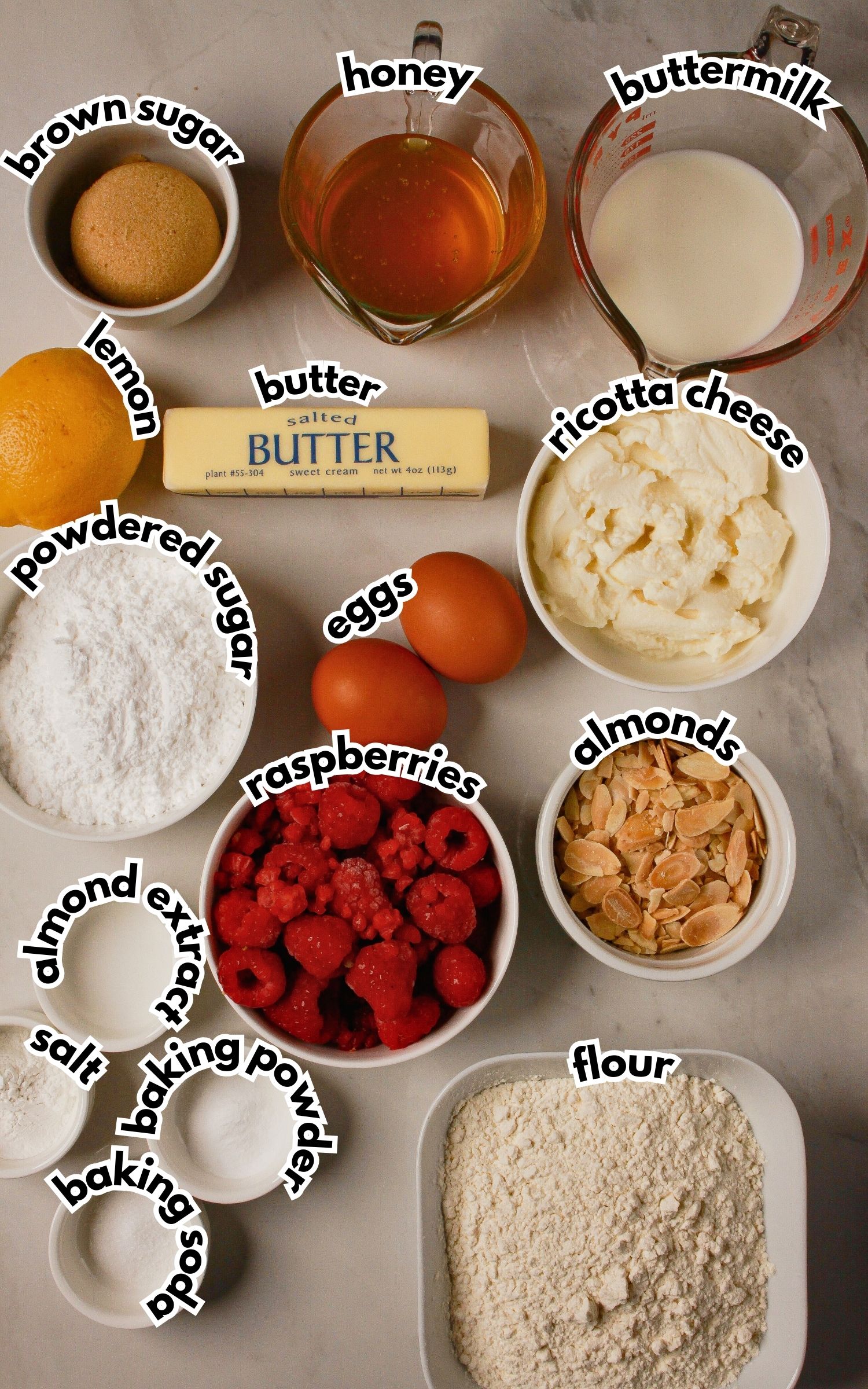 Bowls of ingredients labelled with text on a counter.