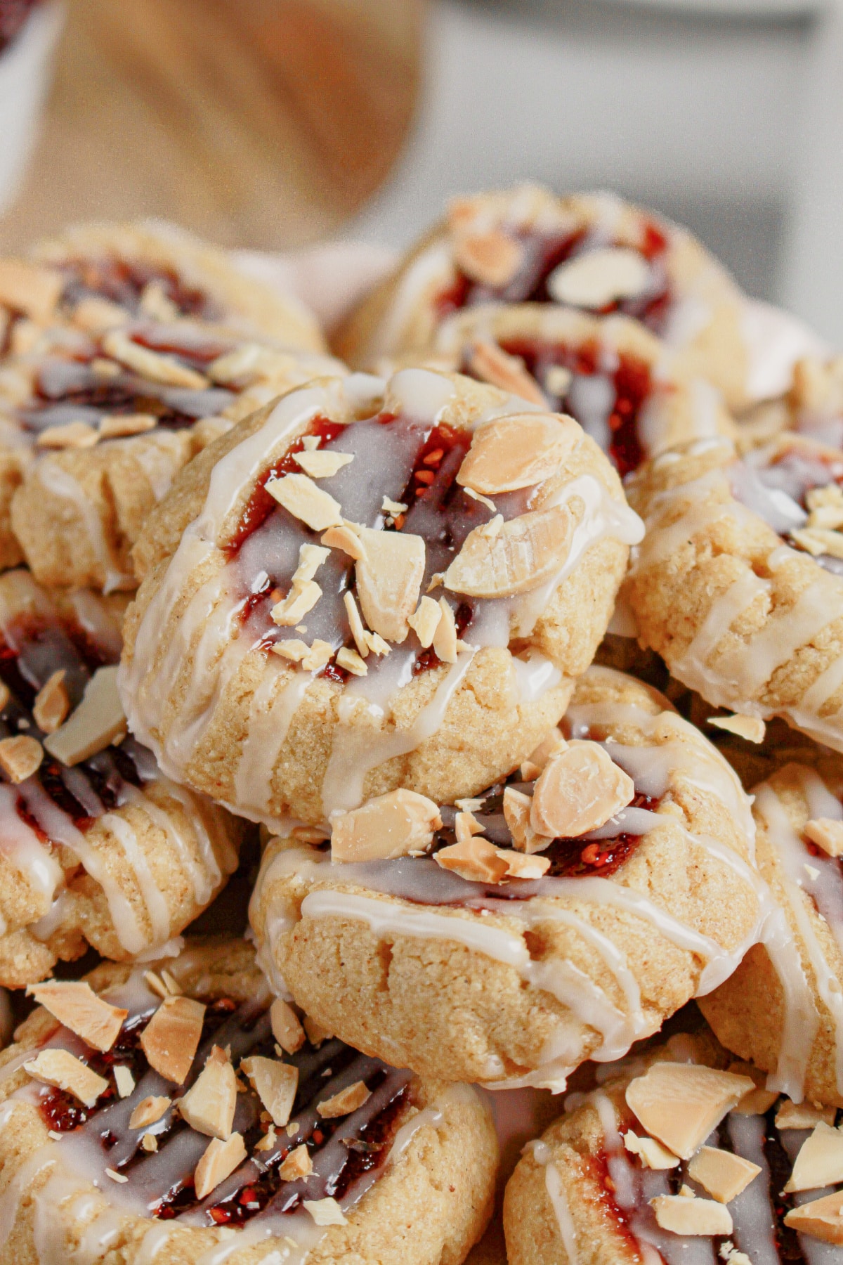Raspberry Thumbprint Cookies stacked on a plate.