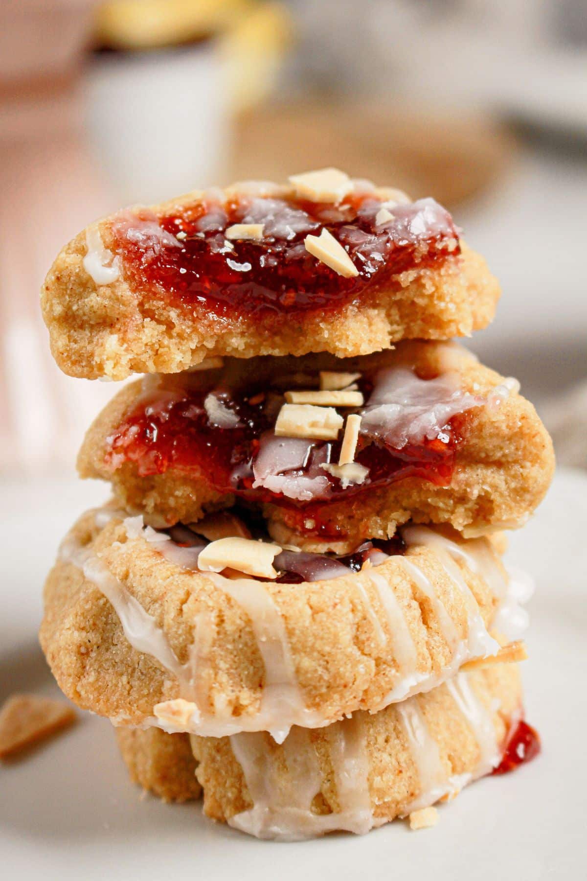Four thumbprint cookies stacked on top of each other.