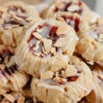 Raspberry Thumbprint Cookies stacked on a plate.