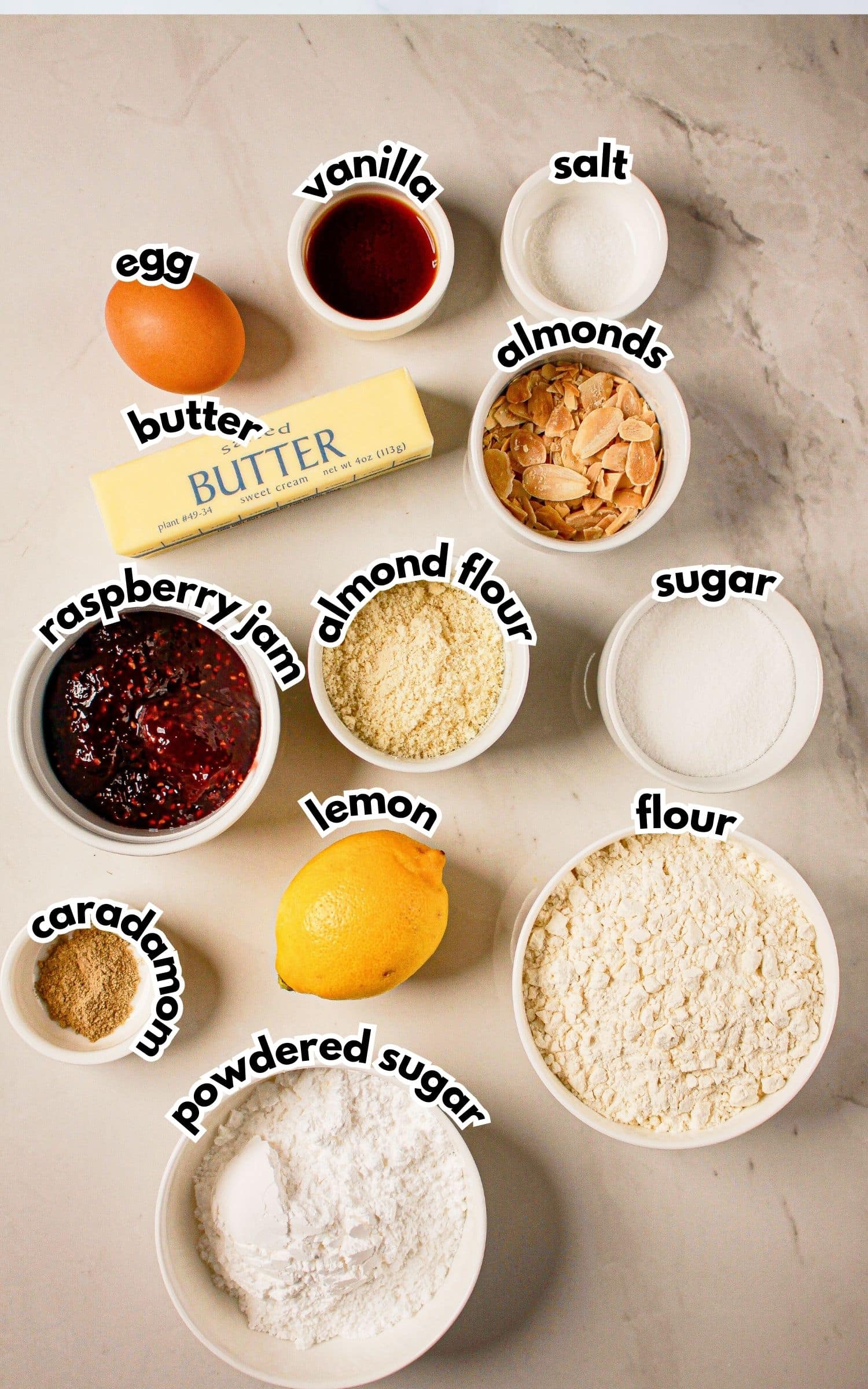 Bowls of ingredients labelled with text on a counter.