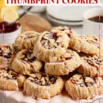 Raspberry Thumbprint Cookies stacked on a plate.
