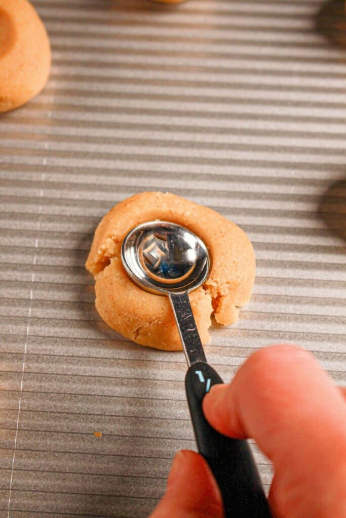 Teaspoon pressing dough down.