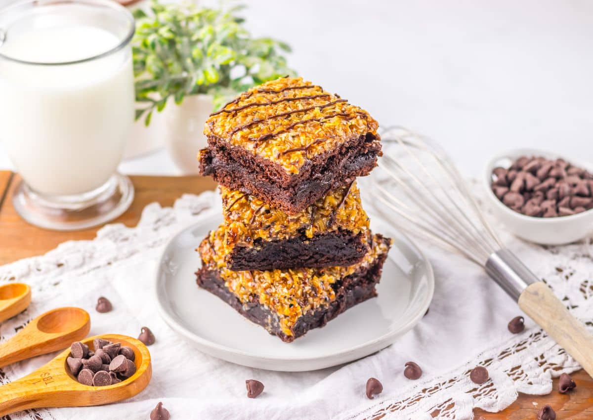 Three brownies stacked on top of each other on a small plate.