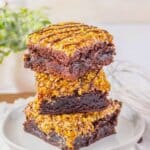 Samoa Brownies Three brownies stacked on top of each other on a small plate.