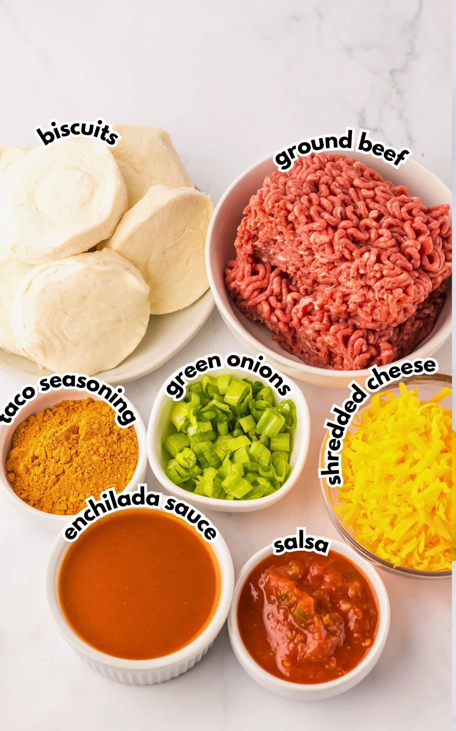 Bowls of ingredients labelled with text on a counter.