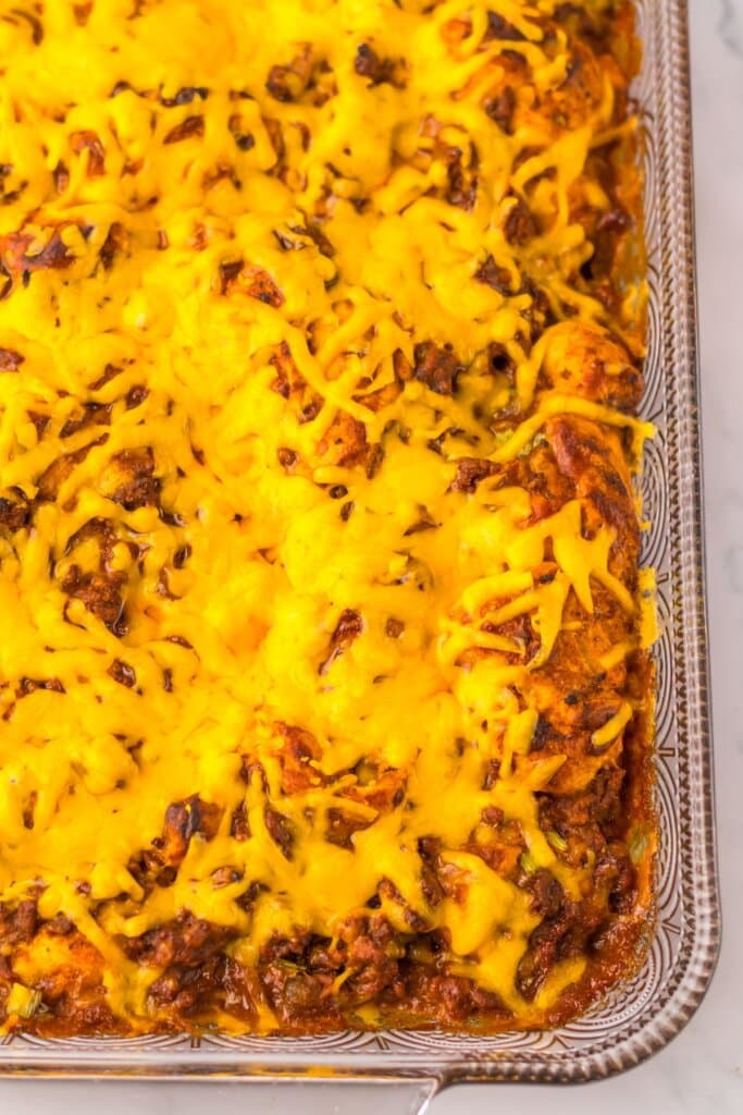 Melted cheese in a glass baking dish.