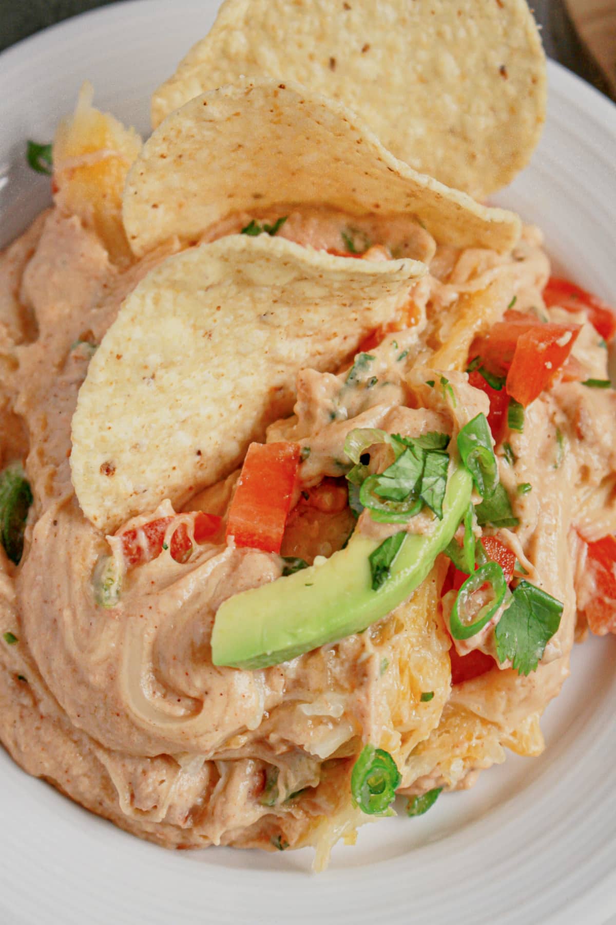 Plate full of Texas trash dip with tortilla chips.