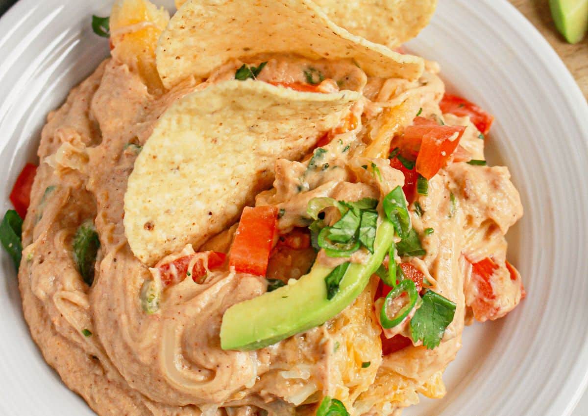 Plate full of Texas trash dip with tortilla chips.