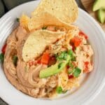 Plate full of Texas trash dip with tortilla chips.