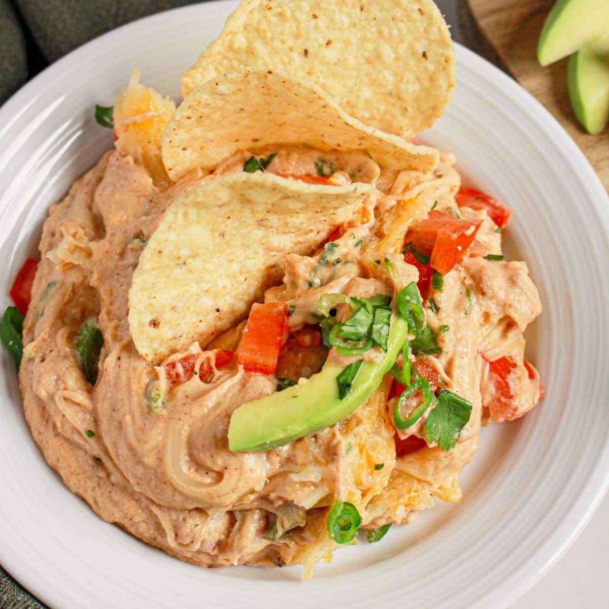 Plate full of Texas trash dip with tortilla chips.
