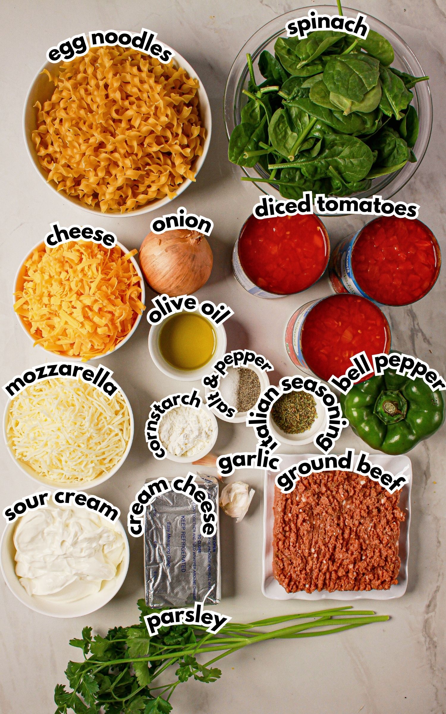 Bowls of ingredients labelled with text on a counter.