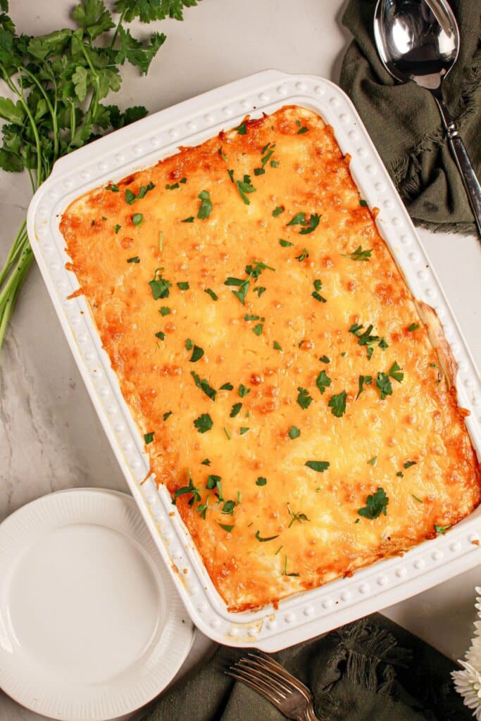 Beef lombardi casserole in a white baking dish.