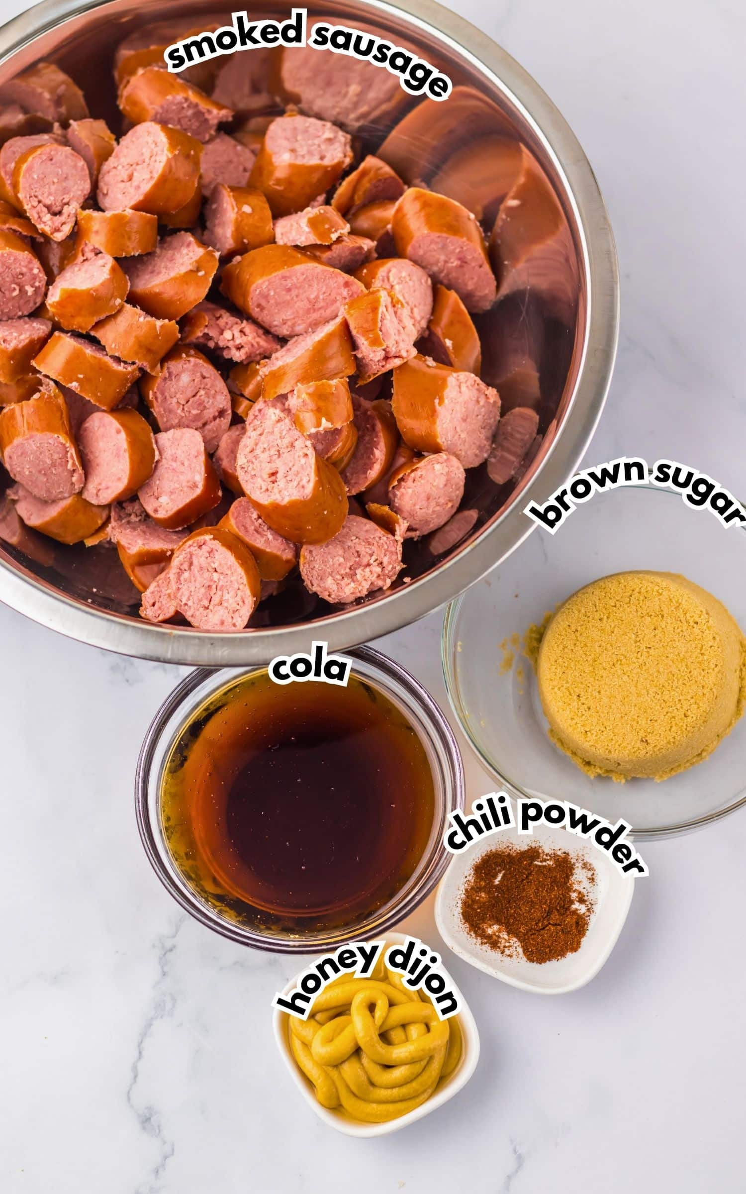 Bowls of ingredients labelled with text on a counter.